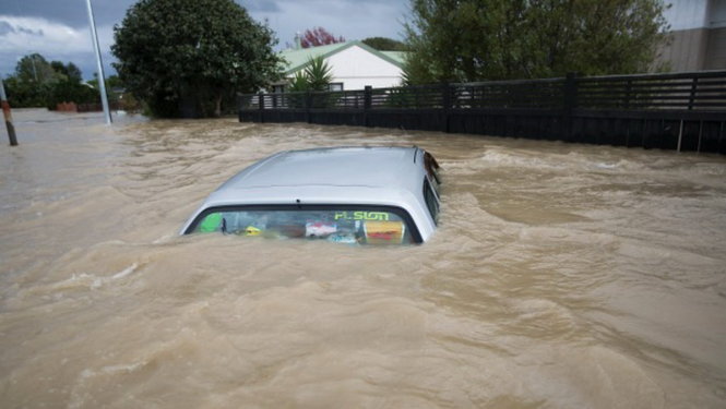 Ô tô bị nước cuốn trôi ở thị trấn Edgecumbe - Ảnh: FAIRFAX