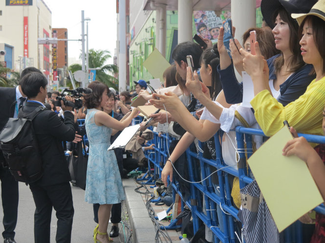 Nghệ sĩ Nhật Bản ký tặng các khán giả hâm mộ tại sự kiện thảm đỏ trưa 23-4 ở Liên hoan phim quốc tế Okinawa lần 9 - Ảnh: Khả Linh