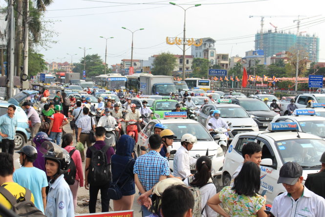 Taxi nối đuôi nhau trước cửa bến xe Nước Ngầm để đón khách khiến giao thông bị ùn ứ - Ảnh: CHÍ TUỆ