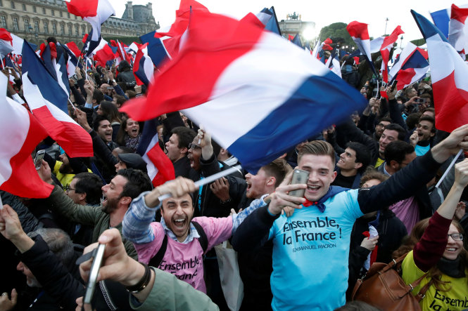 Người ủng hộ ông Macron ăn mừng ở Paris ngày 7-5 - Ảnh: Reuters