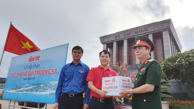 Thiếu tướng Cao Đình Kiếm trao đất cho đại diện báo Tuổi Trẻ với sự chứng kiến của Bí thư T.Ư Đoàn Bùi Quang Huy - Ảnh: VIỆT DŨNG