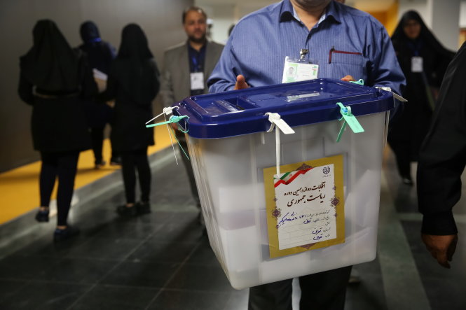 Nhân viên tổ bầu cử đưa thùng phiếu đã niêm phong đi kiểm tại một điểm ở thủ đô Tehran - Ảnh: Reuters