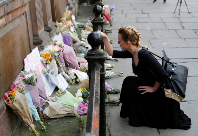 Người dân đặt hoa tưởng niệm các nạn nhân vụ tấn công ở Manchester ngày 23-5 - Ảnh: Reuters