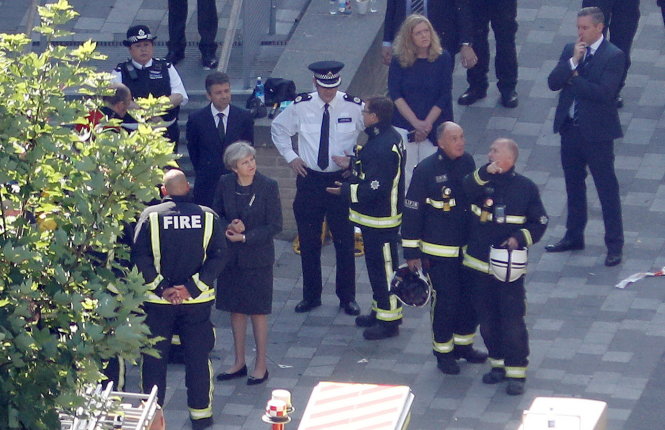 Nữ thủ tướng Theresa May (thứ hai từ trái sang) có mặt tại hiện trường vụ cháy sáng 15-6 - Ảnh: Reuters