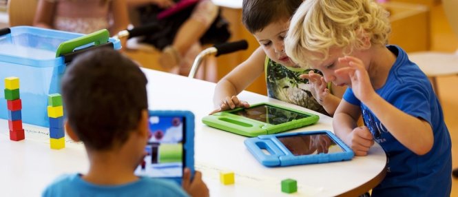 Các em học sinh chơi với iPad - Ảnh: Reuters