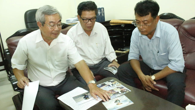 Lãnh đạo Hội Văn học nghệ thuật Trà Vinh so ánh ảnh chụp và tranh của họa sĩ Nguyễn Nhân mà họ cho rằng ông Nhân đã sao chép - Ảnh Tiến Trình