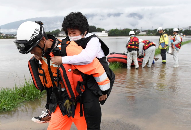 Lực lượng cứu hộ di tản dân tại thành phố Asakura, tỉnh Fukuoka ngày 6-7 - Ảnh: Reuters/Kyodo
