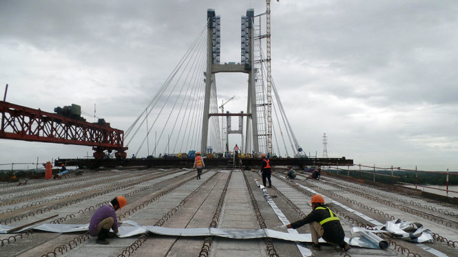Công nhân đang thi công trên mặt cầu Cao Lãnh để chuẩn bị hợp long vào tháng 9-2017