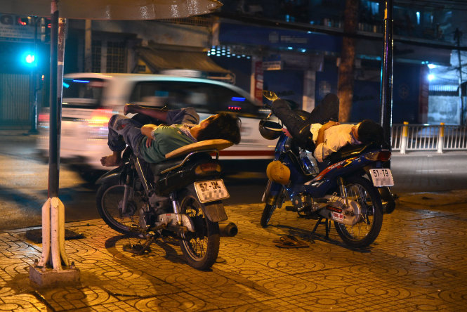 Giấc ngủ đêm của hai bác tài xe ôm trên đường Nguyễn Tri Phương, Q.5, TP.HCM lúc 2h sáng - Ảnh: T.T.D.