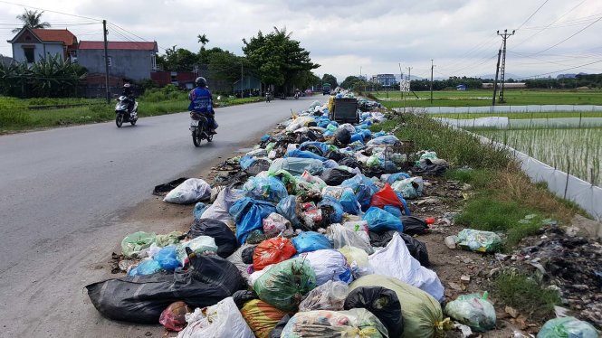 Một điểm tập kết rác tự phát trải dài cả trăm mét trên tuyến đường liên xã của huyện Thủy Nguyên bất chấp biển báo cấm - Ảnh: TIẾN THẮNG