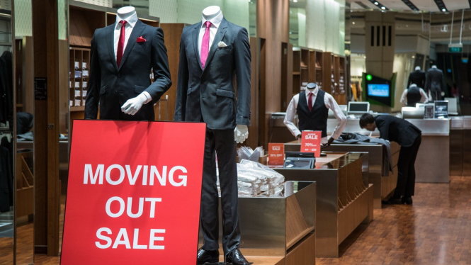 Một cửa hàng thời trang ở trung tâm thương mại Suntect City (Singapore) bán giảm giá để đóng cửa - Ảnh: AFP