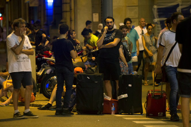 Người dân và du khách đứng bên ngoài khu vực bị phong tỏa sau vụ tấn công ở Barcelona - Ảnh: Reuters