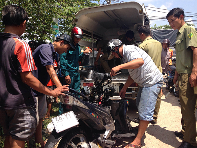 Chiếc xe máy hiệu Yamaha Luvias biến dạng hoàn toàn được đưa từ dưới mương nước lên - Ảnh : Đại Việt