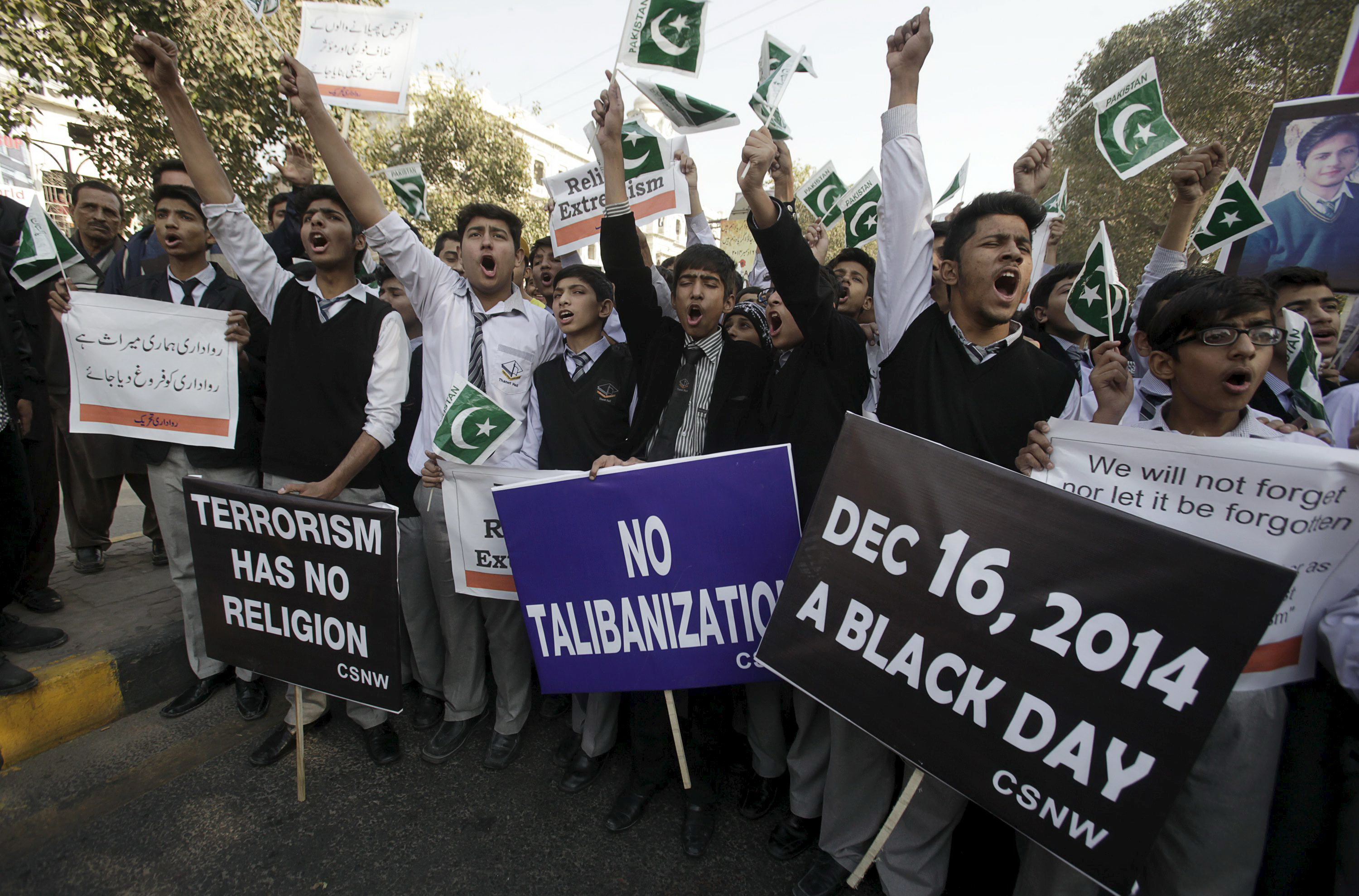 Người dân Pakistan tuần hành phản đối Taliban hôm 15-12, nhân tưởng niệm một năm ngày khủng bố Taliban tấn công trường học ở Peshawar - Ảnh: Reuters