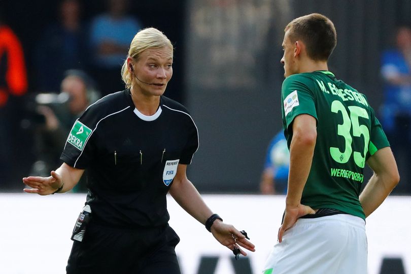 Steinhaus (trái) trao đổi với cầu thủ Bremen sau một tình huống thổi phạt. Ảnh: DBF